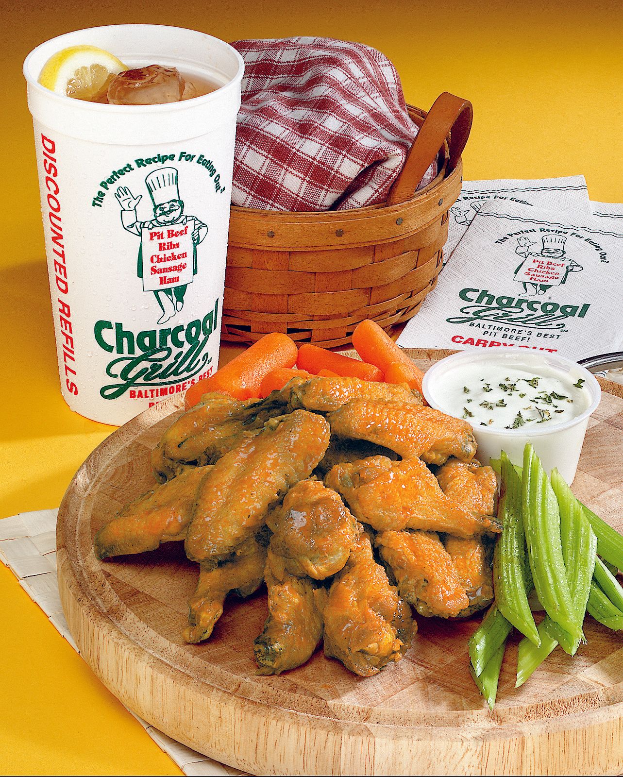 Wings with celery, carrots and ranch on a wooden board